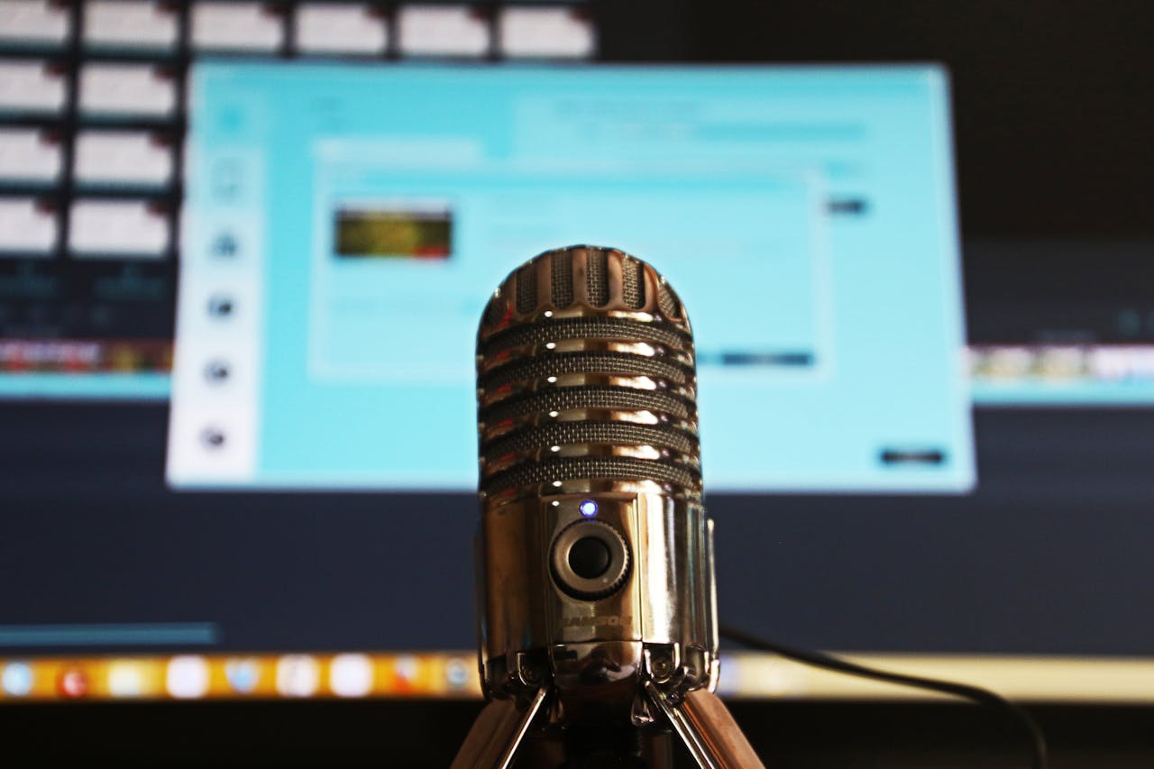 Mastering the First Impression: Your intriguing post title goes here Close-up of a microphone with a blurred computer screen in the background, ideal for podcast themes.
